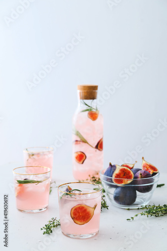 Composition with tasty fig lemonade on light background