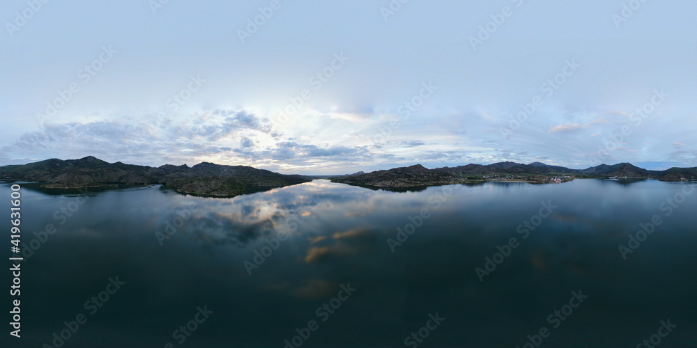Panorama of the lake in the mountains in the evening