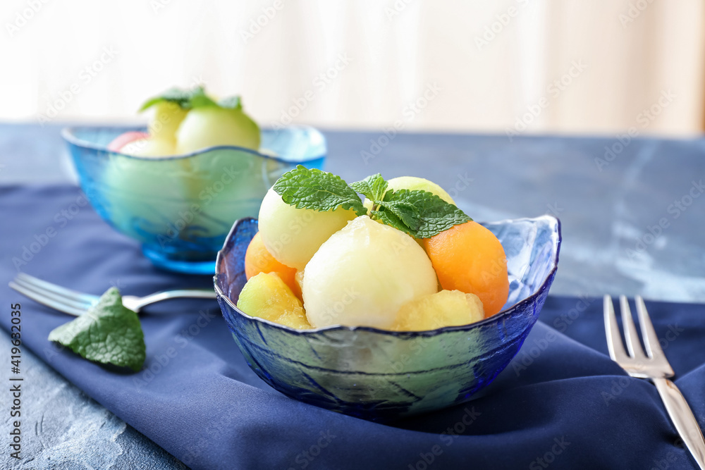 Bowls with sweet melon balls on color background Bowls with sweet melon balls on color background