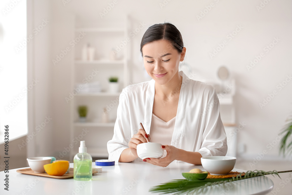 Beautiful young woman with cosmetic products in bathroom Beautiful young woman with cosmetic products in bathroom