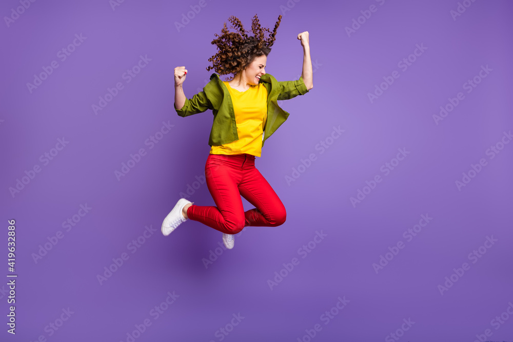 Full size photo of young happy excited crazy smiling girl say yes jumping in victory isolated on violet color background