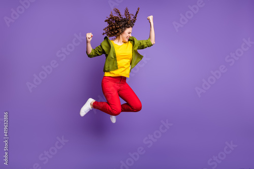 Full size photo of young happy excited crazy smiling girl say yes jumping in victory isolated on violet color background