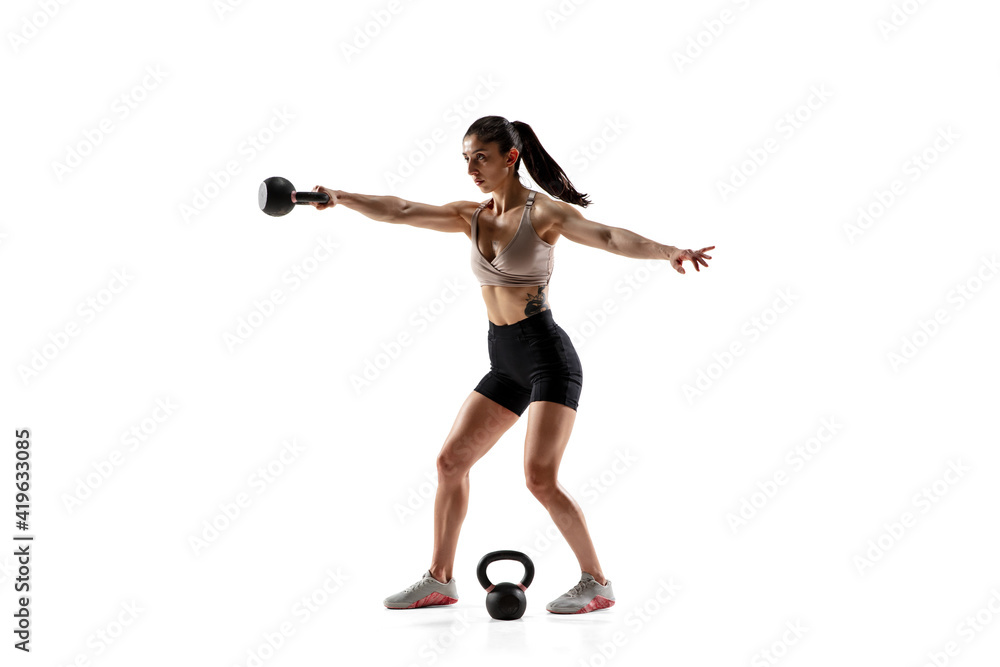 Balance. Caucasian professional female athlete training isolated on white studio background. Muscular, sportive woman. Concept of action, motion, youth, healthy lifestyle. Copyspace for ad.