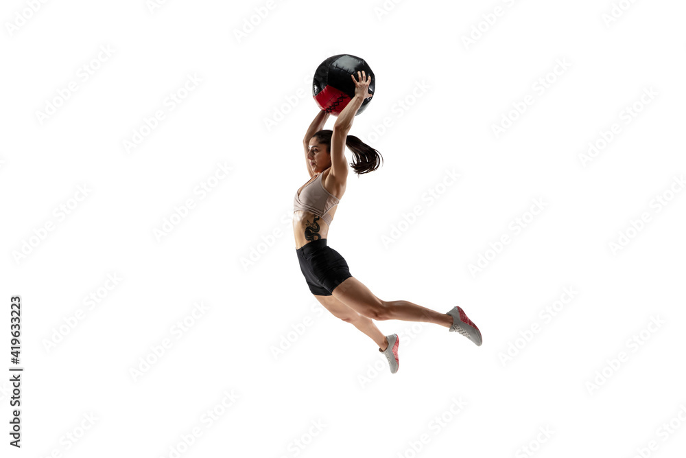 In air. Caucasian professional female athlete training isolated on white studio background. Muscular, sportive woman. Concept of action, motion, youth, healthy lifestyle. Copyspace for ad.
