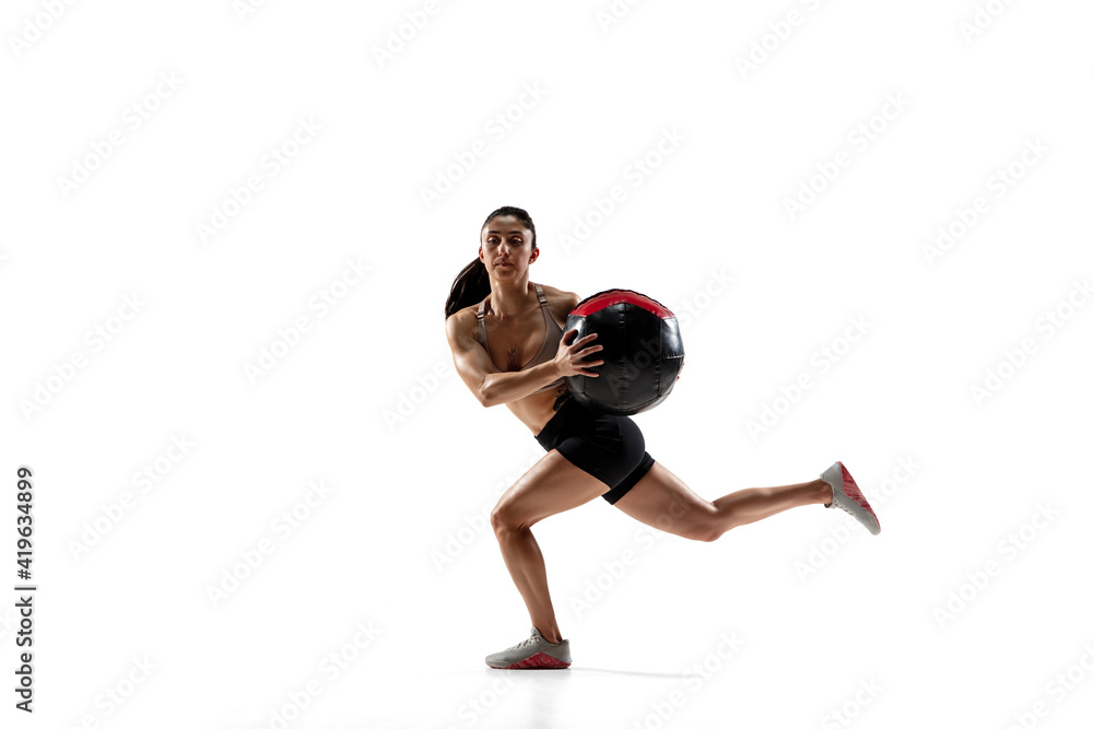 Ball practice. Caucasian professional female athlete training isolated on white studio background. Muscular, sportive woman. Concept of action, motion, youth, healthy lifestyle. Copyspace for ad. Ball practice. Caucasian professional female athlete training isolated on white studio background. Muscular, sportive woman. Concept of action, motion, youth, healthy lifestyle. Copyspace for ad.