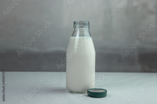 Milk in a glass bottle. Isolated milk on the table. Milk product.