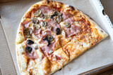 Family pizza, half of oval, consists of two types, margarita, prosciutto fungi. Food delivery concept, takeaway, cuisine, fast food, togetherness. Top view, flat lay, close-up. Authentic lifestyle.