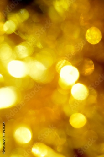 Elegant golden yellow caramel abstract natural bokeh light background. Good for party invitation text or other decorative ideas. © Natalie Ducouer