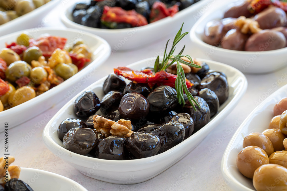 varieties of olives on the plate on a white background varieties of olives on the plate on a white background