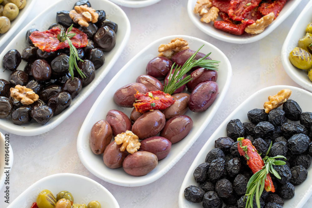 varieties of olives on the plate on a white background varieties of olives on the plate on a white background