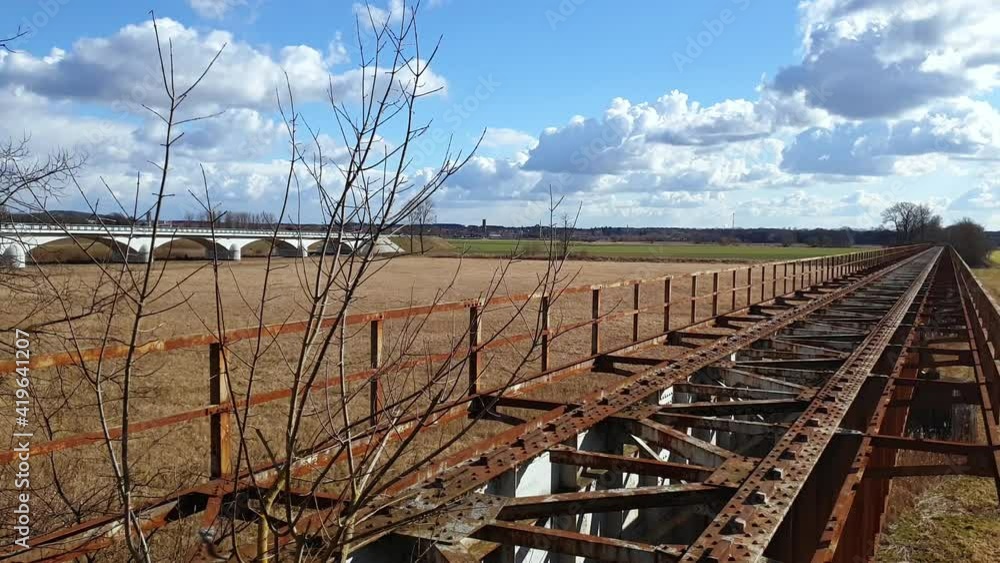 A disused railway bridge in Skwierzyna, Poland. Sunny day, sharp light, paning from left to right A disused railway bridge in Skwierzyna, Poland. Sunny day, sharp light, paning from left to right