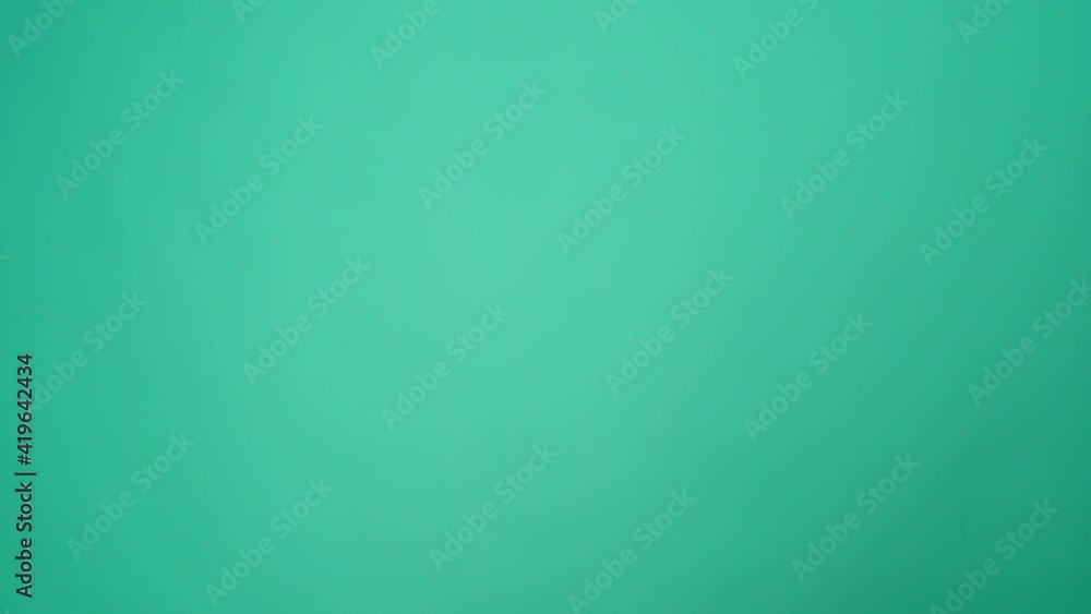 People hands passing one another cup of coffee to go against mint background People hands passing one another cup of coffee to go against mint background