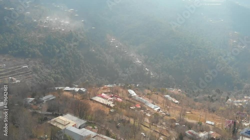 Aerial View Of Misty Hillside Landscape Of Muzaffarabad In Pakistan. Slow Dolly Forward photo