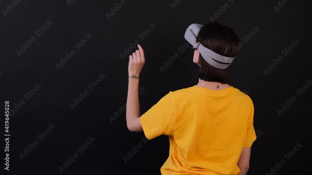 Woman in vr glasses click to left two times on background with finger Woman in vr glasses click to left two times on background with finger