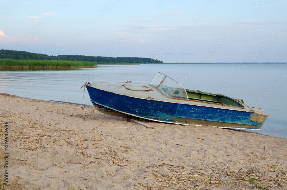 Boat on the shore of Lake Seliger on a summer evening. Tver Region, Russia