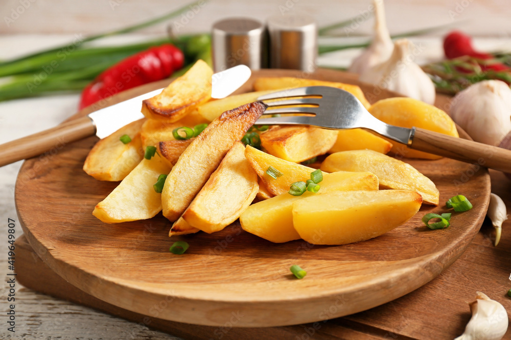 Plate of tasty baked potato with garlic, closeup