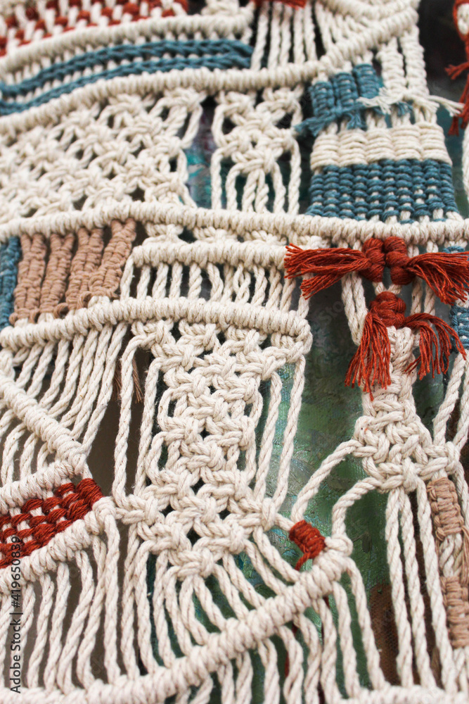 Macrame made with blue and white tile colored threads. Macrame in various patterns made with colored threads.