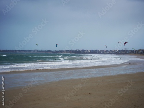 Panorama view of kitboard kitesurfing windsurfing on Grande Plage du Sillon Rochebonne beach Saint Malo Brittany France photo