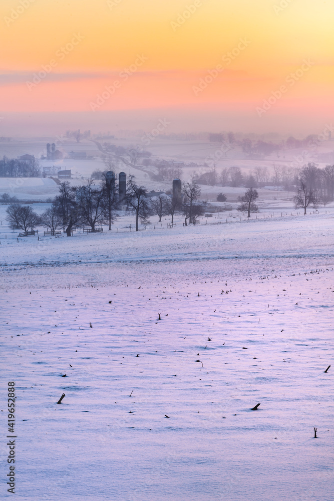 Naklejka premium Sunrise over fields