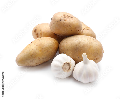 Potatoes and garlic on white background