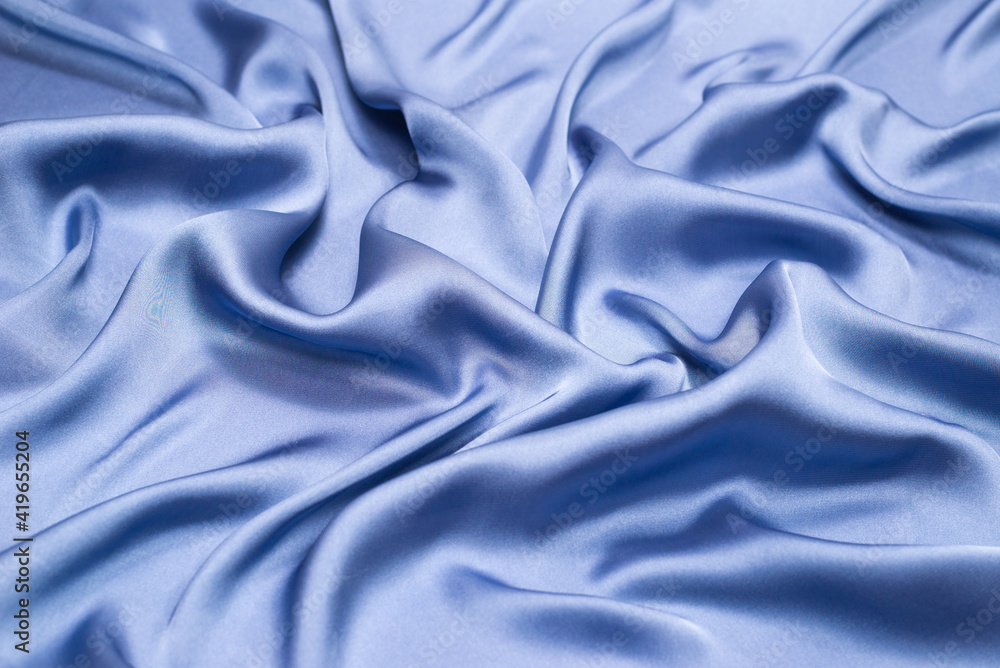 Obraz premium Blue silk or satin luxury fabric texture. Top view.