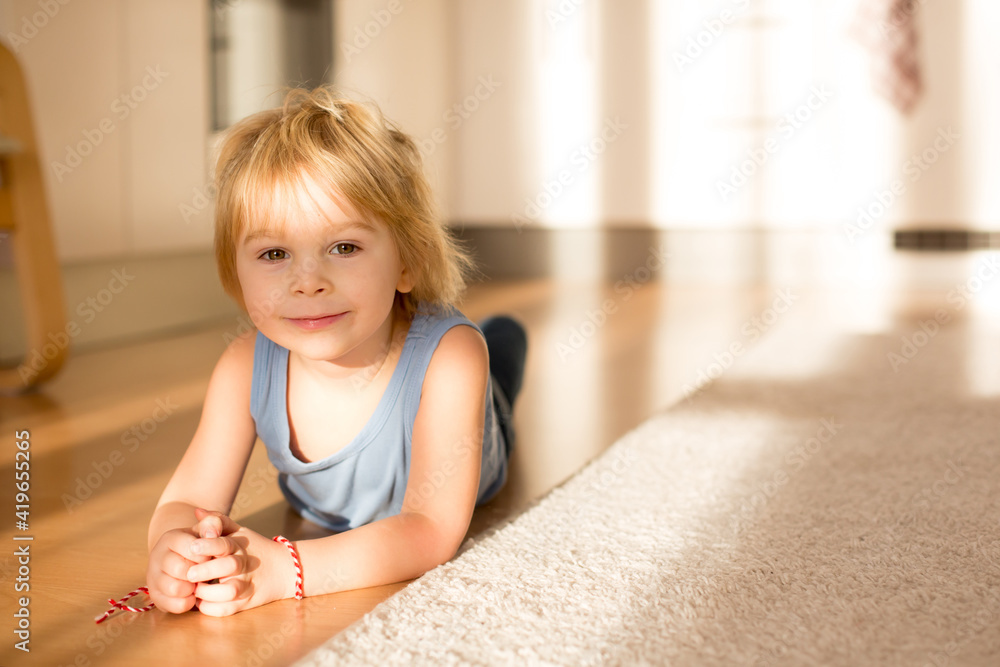 Cute blond toddler child, playing with big toy car Cute blond toddler child, playing with big toy car