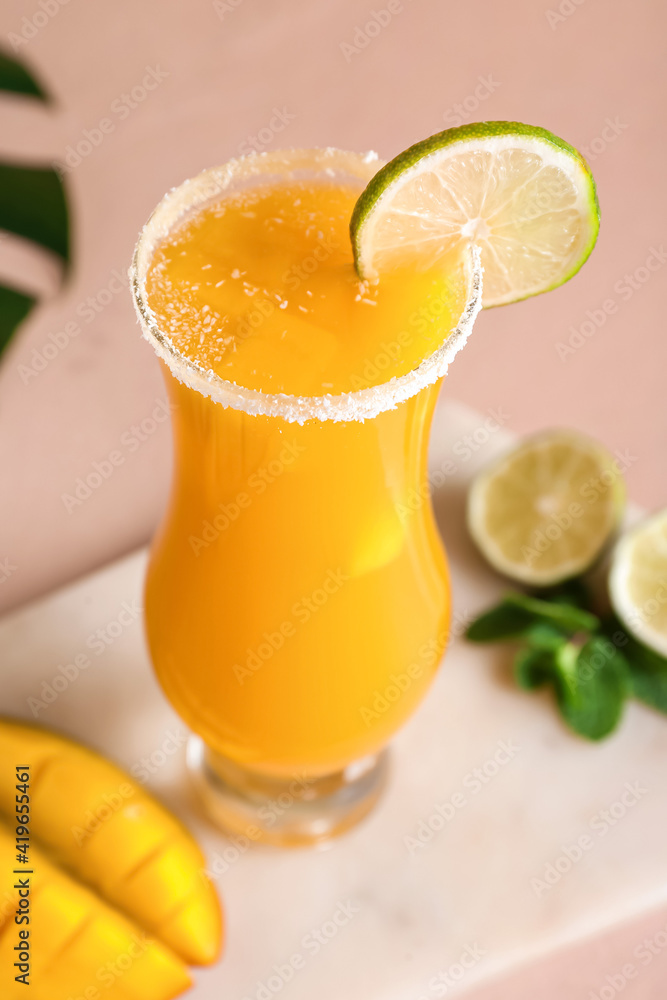 Glass of tasty mango margarita on color background Glass of tasty mango margarita on color background