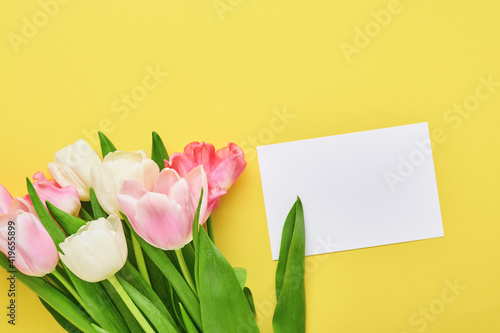 Fototapeta Naklejka Na Ścianę i Meble -  Pink tulip flowers bouquet on front of yellow background. Greeting card. With copy space.