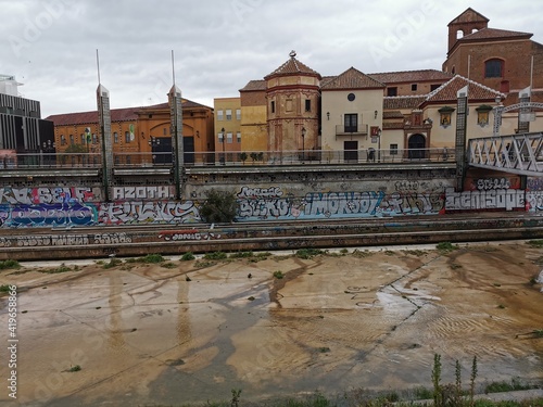 Málaga, Spain - February 21, 2021: View of streets of Soho Málaga in a rainy day.