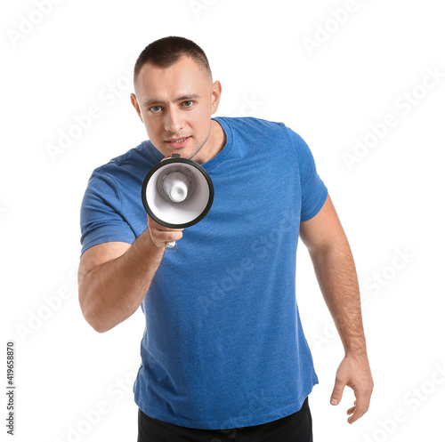 Handsome young man talking into megaphone on white background