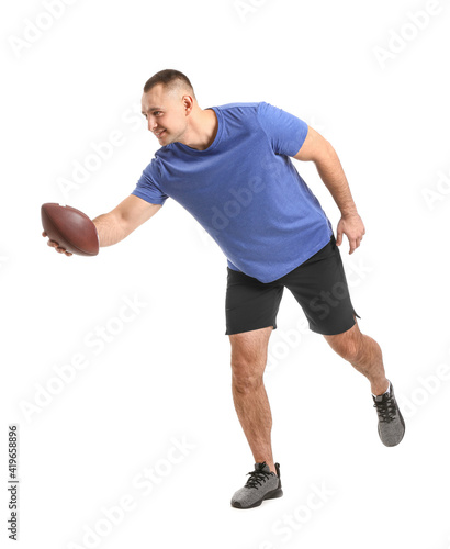 Handsome young man with rugby ball on white background