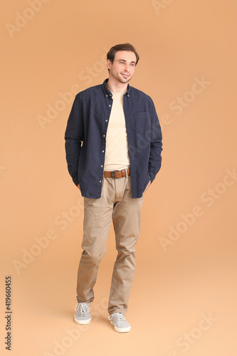Handsome young man on color background © Pixel-Shot