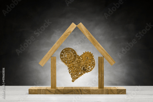 Golden heart made with metallic gears into iconic home