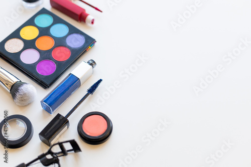 Bright multi-colored decorative cosmetics on a light background