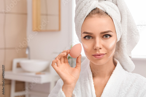 Beautiful young woman apply...