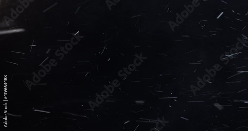 4k Slow-motion VFX Blizzard element. Dense heavy blizzard snowstorm VFX insert in slow-motion on black screen. Black screen Christmas snowstorm. Particles swirling moved by wind. photo