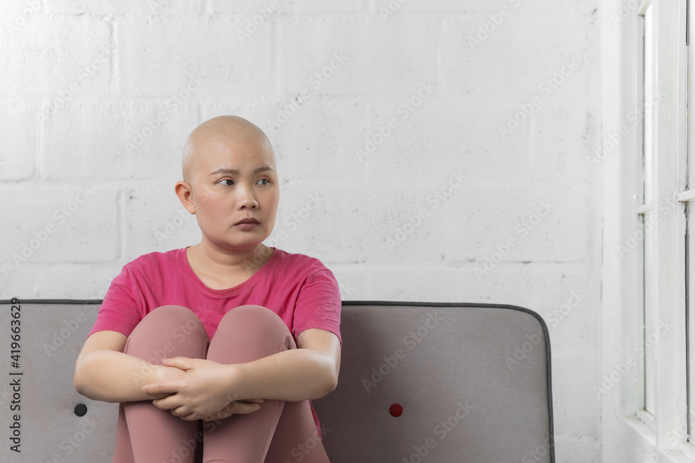 Portrait of sad Asian woman cancer patient after suffering serious hair loss due to chemotherapy Portrait of sad Asian woman cancer patient after suffering serious hair loss due to chemotherapy
