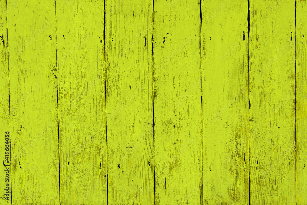 Bright old yellow painted wooden planks. Close-up. Vertical view. Background. Texture. Bright old yellow painted wooden planks. Close-up. Vertical view. Background. Texture.