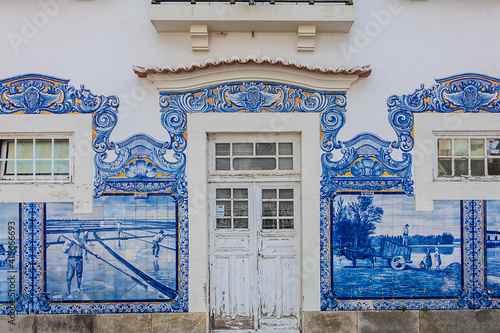 External view of Historic building of old Aveiro Railway station ornamented with typical blue azulejos tile exterior, which tells a story of life in traditional Portugal. Aveiro, Portugal. photo