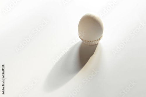 White egg on a white isolated background with shadow. Ingredient.Healthy food.Easter.
