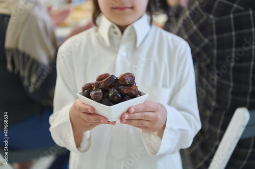 Arabian kid in the traditional clothes during iftar