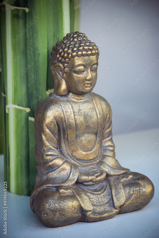 Closeup of golden buddha statue in a store showroom