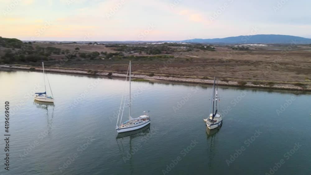 Aerial view of group of sailboats anchoring in Alvor Bay, Portugal 1 Aerial view of group of sailboats anchoring in Alvor Bay, Portugal 1