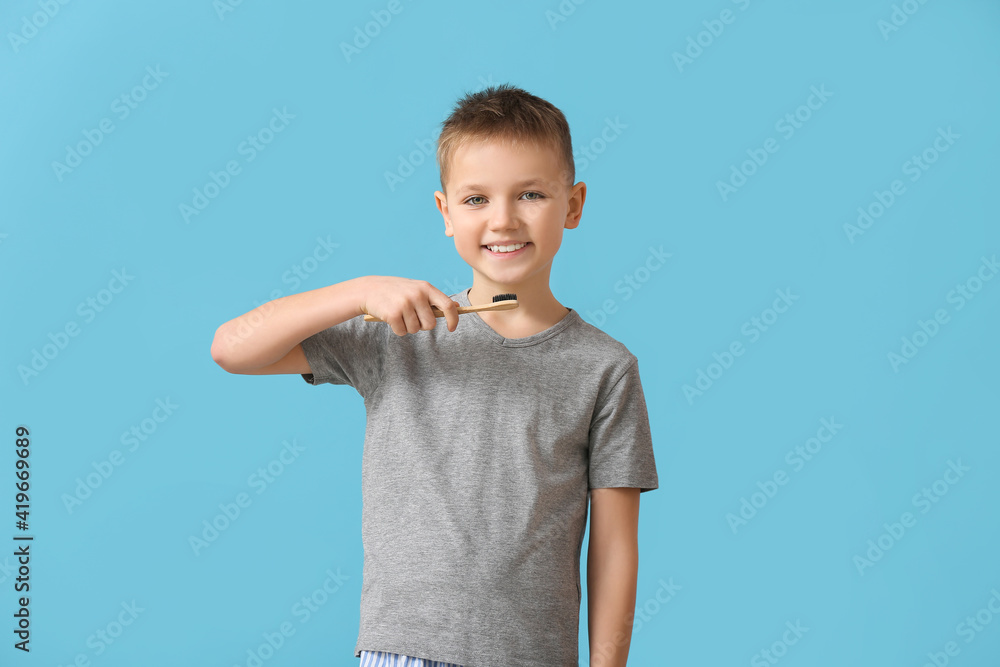 Little boy brushing teeth on color background Little boy brushing teeth on color background