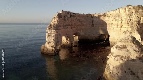 Aerial view of cliff arch during sunrise at Marinha Bay, Portugal 2