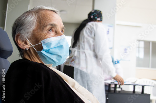 Senior adult under observation to monitor any adverse effects attributable to the vaccine after the application of the first dose against Covid-19 photo
