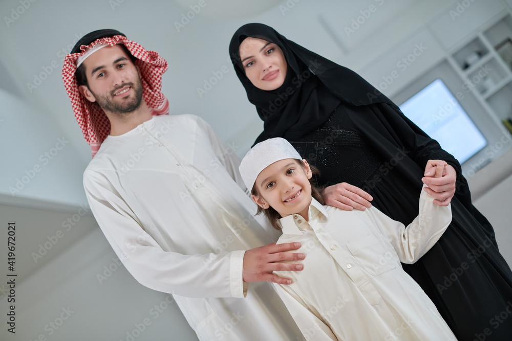 Portrait of young arabian muslim family wearing traditional clothes