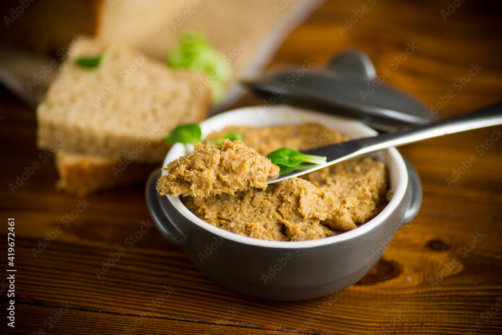homemade meat pate in a ceramic bowl on a wooden table homemade meat pate in a ceramic bowl on a wooden table