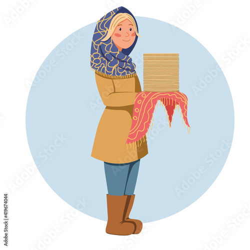 A girl in a scarf with pancakes in her hands. Pancake day. Shrovetide carnival. The great Russian holiday.