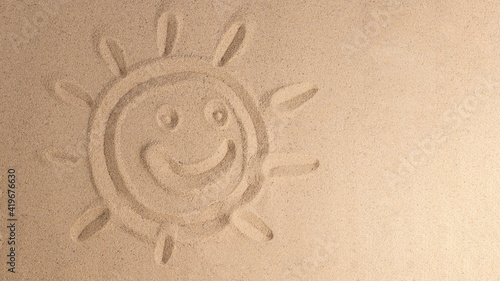  Symbol of sun drawing on sand, background for vacation. Summer background with copy space